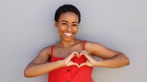woman in red smiling heart hands